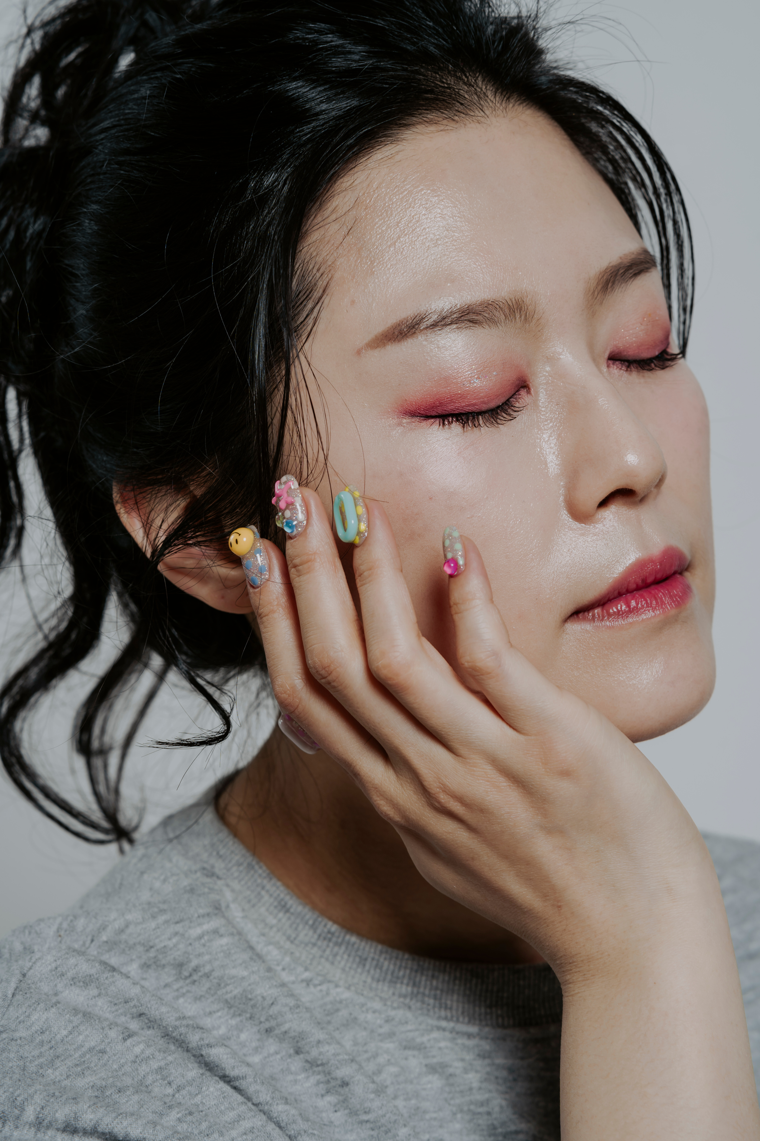 Woman with Makeup Showing Nail Art