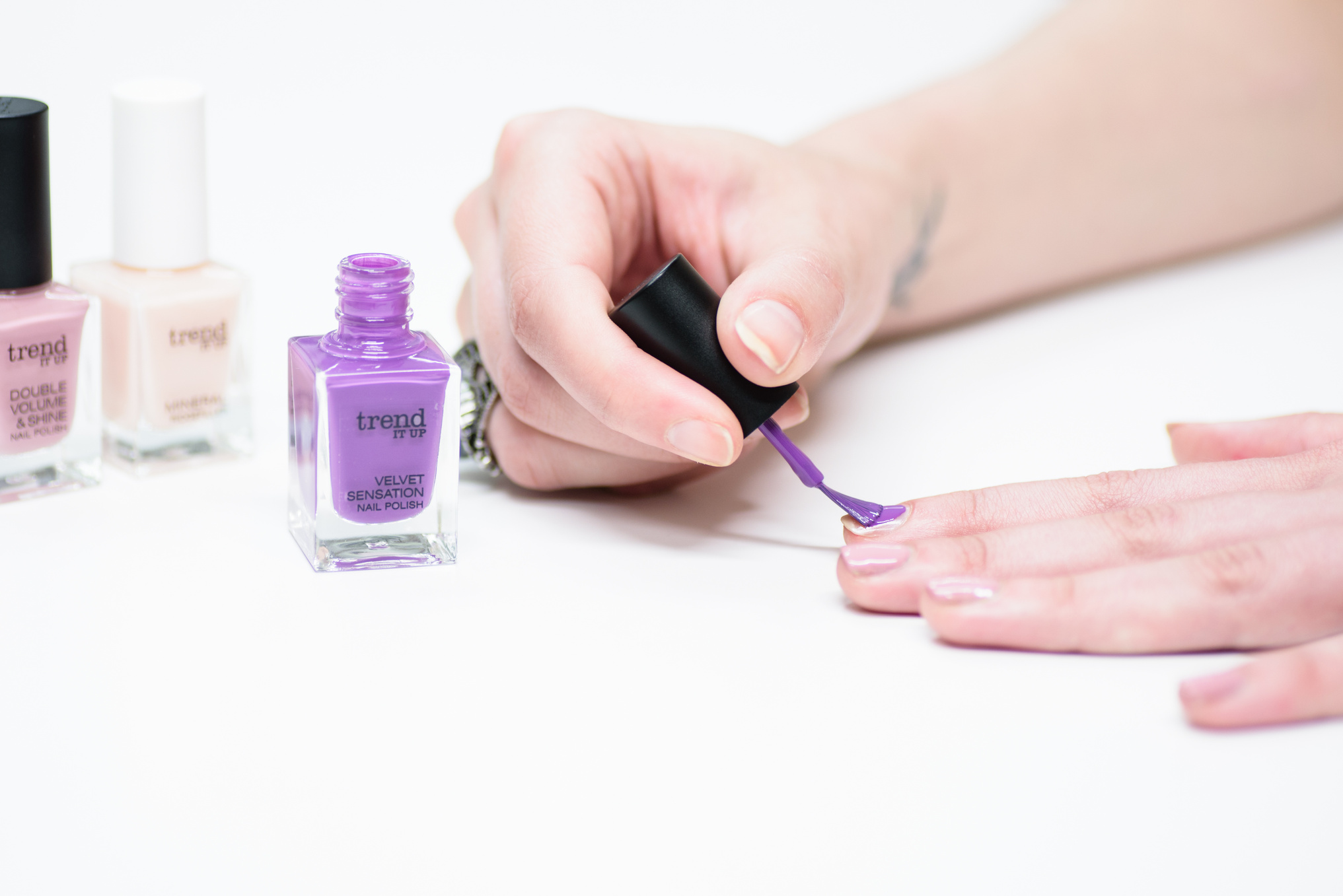 A Person using Purple Nail Polish